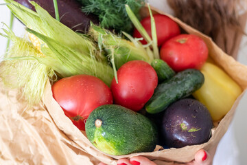 Shot of the woman holding paper bag with fresh herbs and vegetables. Lifestyle