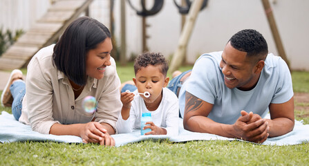 Wall Mural - Outdoor, parents and child in backyard with bonding, connection and together for family, fun and support. Woman, man and happy toddler in blowing bubbles, care and love for playful, garden and picnic