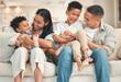 © peopleimages.com - Parents, kids and laugh in home at living room on portrait for fun, support and care. People, family and happy on sofa for bonding with siblings for childcare or child development on break and relax