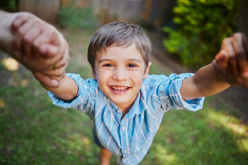 Sticker - Son, spinning and parents hands in garden, smile portrait and kid for childhood fun in summer for weekend break. Game, bonding and pov with happiness motion, backyard and together in sunshine