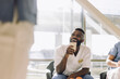 © Maskot - Happy male medical worker holding disposable cup while sitting in cafeteria