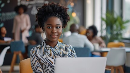 Attractive african young confident businesswoman sitting at the office table with group of colleagues in the background, working on laptop computer - generative ai