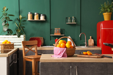 Sticker - Wicker basket with citruses on counter in green kitchen