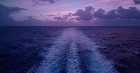 a captivating cinematic shot of the sea with deep blue water and an enchanting horizon at sunset.