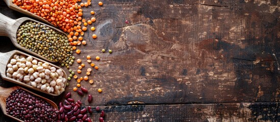Aufkleber - Various types of legumes like lentils soybeans chickpeas and red kidney beans arranged on a rustic brown table with adequate space for text in a copy space image