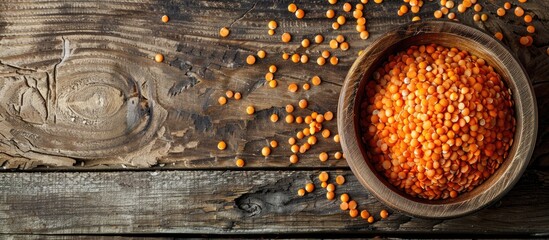 Leinwandbilder - Red lentil bowl arranged on a wooden surface with copy space image