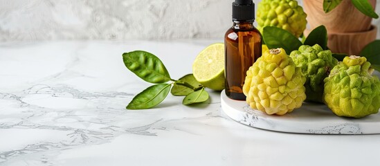 Poster - Fresh bergamot fruits and a bottle of essential oil displayed together on a white marble table with a spacious area available for adding text. with copy space image. Place for adding text or design