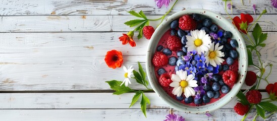 Poster - Top down view of a delectable smoothie bowl adorned with fresh fruits blueberries and flowers Placed on a white wooden surface offering ample copy space image