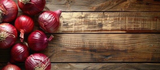 Aufkleber - Red Onions on a bright wooden surface creating a backdrop for text with a focused view from above suitable for a copy space image