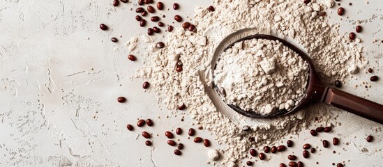 Aufkleber - Top down view of a spoon resting on kidney bean flour sprinkled with brown seeds providing ample copy space image