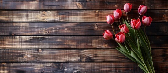 Fototapete - Tulip bouquet displayed on a wooden backdrop with a copy space image