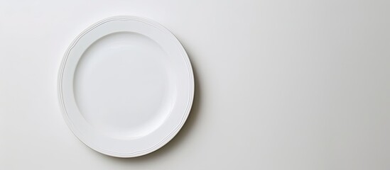 Poster - Top view of an unblemished plate on a white backdrop with copy space image
