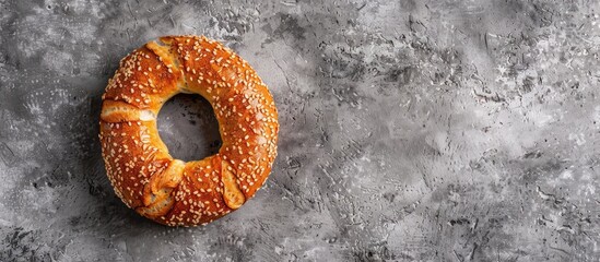 Aufkleber - Top view of a traditional Turkish Bagel Simit with sesame on a gray background providing ample copy space for text or images