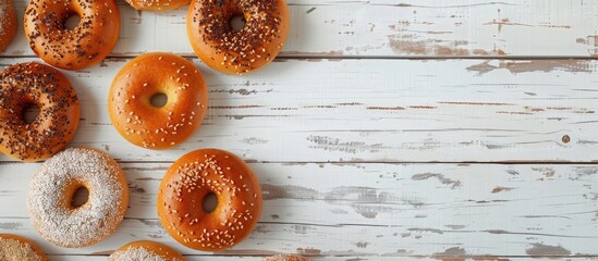 Fototapete - Mini bagels drying on white wood backdrop with copy space image