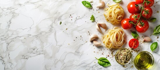 Fototapete - An Italian inspired Mediterranean dinner concept with ingredients like dried pasta garlic olive oil basil and tomatoes on a white stone background for a top view with copy space image