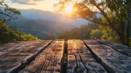 Sunset view of mountain landscape with wooden table in foreground. Perfect for showcasing products with serene natural backgrounds.