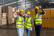 © Jack Tamrong - Group of diversity warehouse men and woman workers raising hands cheerful in distribution warehouse