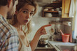 © Aodsy - A couple arguing in the kitchen, with the woman pointing and expressing frustration while the man listens intently.