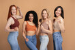 © Maria Vitkovska - Diverse group of multiracial women wearing stylish tank top celebrating isolated on beige background