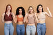 © Maria Vitkovska - Diverse group of multiracial women wearing stylish tank top celebrating isolated on beige background