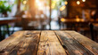 © CreativeCreations - Empty rustic wood table and blurred soft light table in restaurant with bokeh background. product display template.Business presentation.