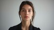 © VISUAL BACKGROUND - A woman in a black shirt is looking at the camera