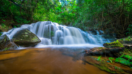 Wall Mural - Beauty in nature, amazing waterfall in tropical forest of national park, Thailand