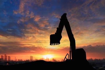 Canvas Print - Crawler excavators silhouette are digging the soil in the construction site. on  sunset background