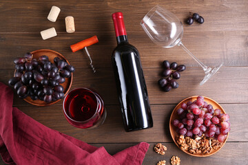 Wall Mural - Flat lay composition with corkscrew and red wine on wooden table