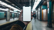 © oxart_studio - Hand Holding Blank Screen Mockup Phone With Green Train And Platform In Subway Station
