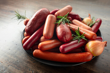 Wall Mural - Various sausages with rosemary and onion.