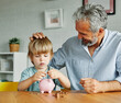 © Lumos sp - child money saving grandfather family coin senior finance bank piggybank happy investment grandson boy financial elderly cash