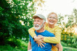 © Lumos sp - outdoor senior fitness woman man love active fun piggyback exercise healthy fit sport retirement happy adult couple mature exercising nature activity old elderly wife husband embracing