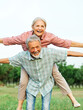 © Lumos sp - woman man outdoor senior couple happy lifestyle retirement together smiling love fun elderly active vitality nature mature portrait piggyback game