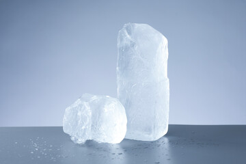 Poster - Pieces of clear ice and water drops on light grey table