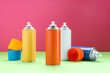 © New Africa - Many spray paint cans on color background