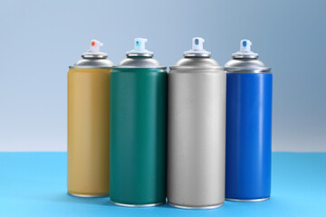 Poster - Many spray paint cans on color background