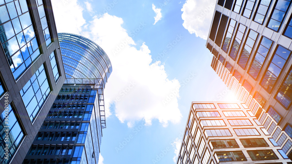 Glass facade of the buildings with a blue sky. Skyscrapers in the ...