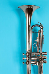 Wall Mural - One trumpet on light blue background, top view