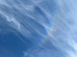 beautiful blue sky with rainbow, low angle view