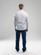 © opolja - rear view of elegant man standing in front of white background.