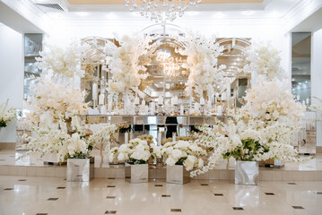 Wall Mural - reception table in a restaurant decorated with white flowers and candles..