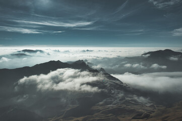 Abstract mountain landscape with clouds and mists