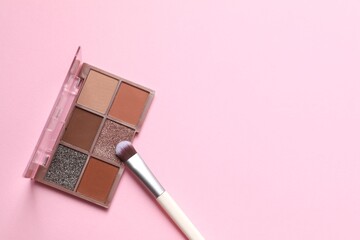 Make-up palette with brushes on a colored background