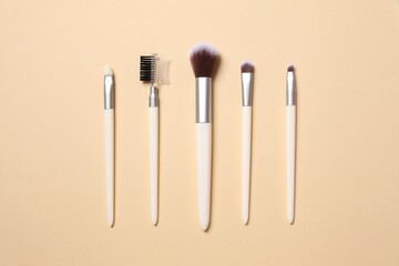 Cosmetic brushes on colored background. Set of makeup brushes