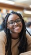 © ANC Media - A smiling African American student engages with peers in a classroom