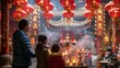 © Sasint - Family visiting a temple adorned with Lunar New Year decorations, offering prayers