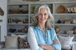 © GraysonStock - A gray-haired businesswoman recruiter, standing with her arms folded and smiling amicably, said, 'I'm a businesswoman.