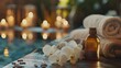 © bersch28 - Relaxing spa setup with essential oils and towels near a tranquil pool at dusk