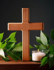 Wall Mural - Wooden cross, candle and green leaves, serene symbol. Religious, spiritual, meditation theme